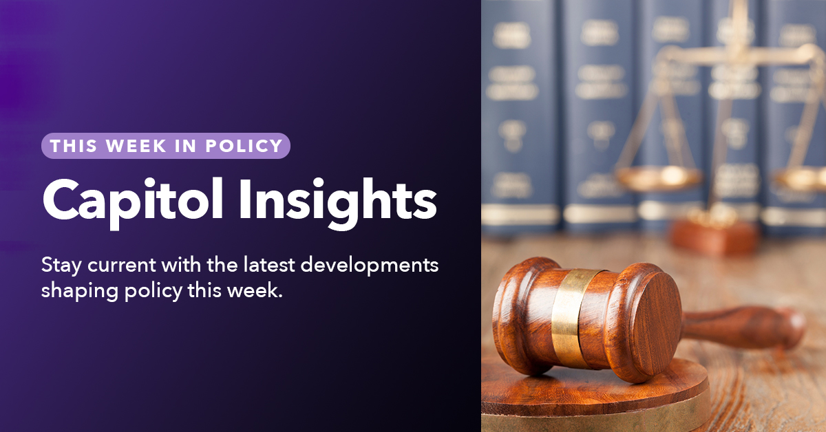 A judge's gavel lays on a desk with law books and scale