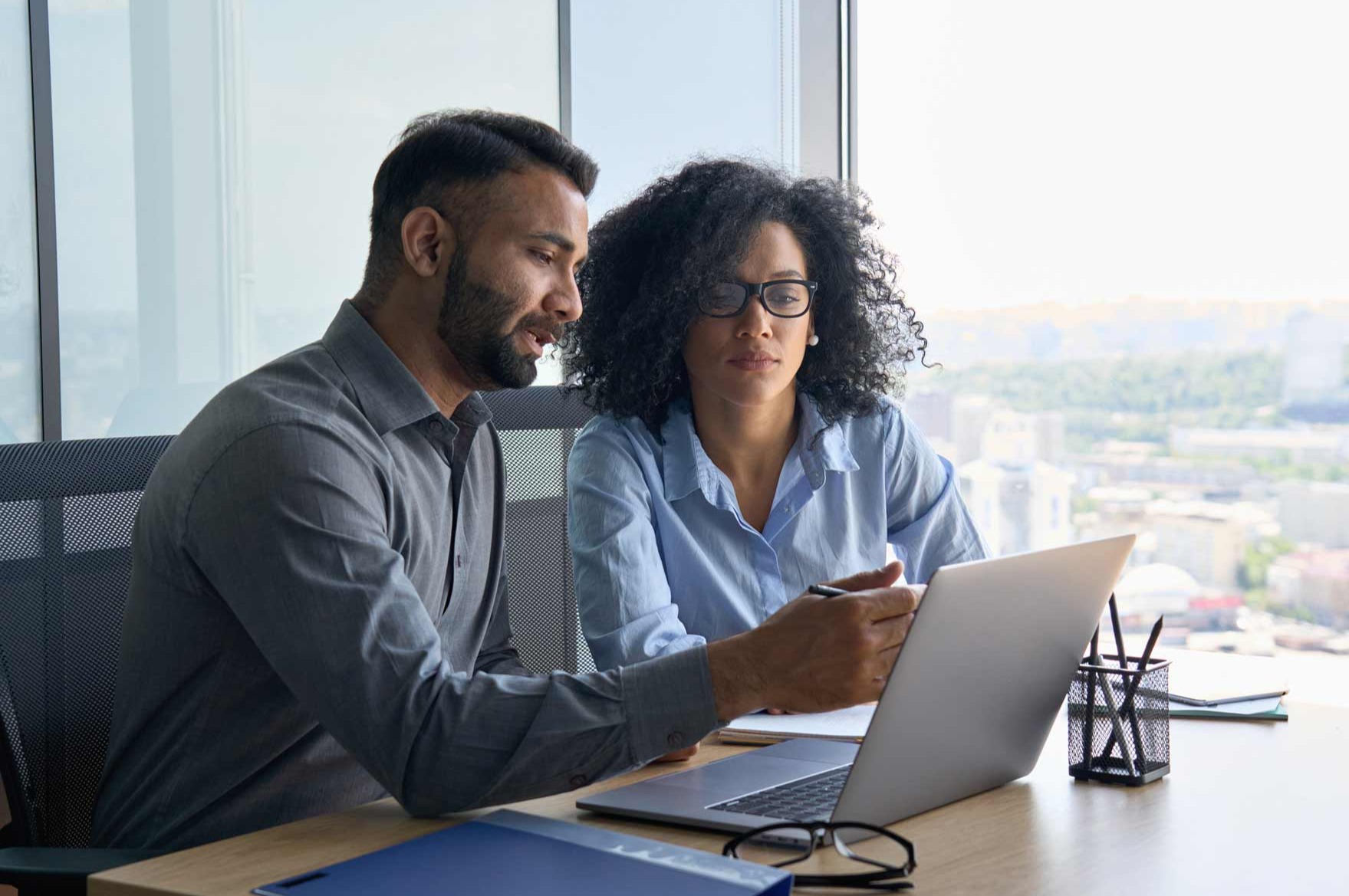 woman-man-reviewing-paperwork-office